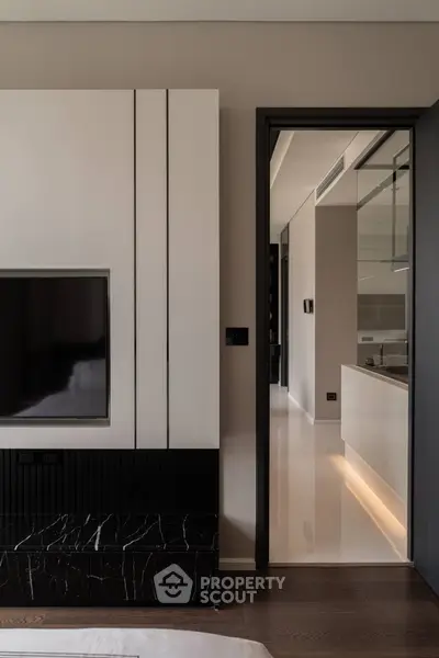 Modern interior with sleek kitchen and stylish living area, featuring elegant finishes and contemporary design.