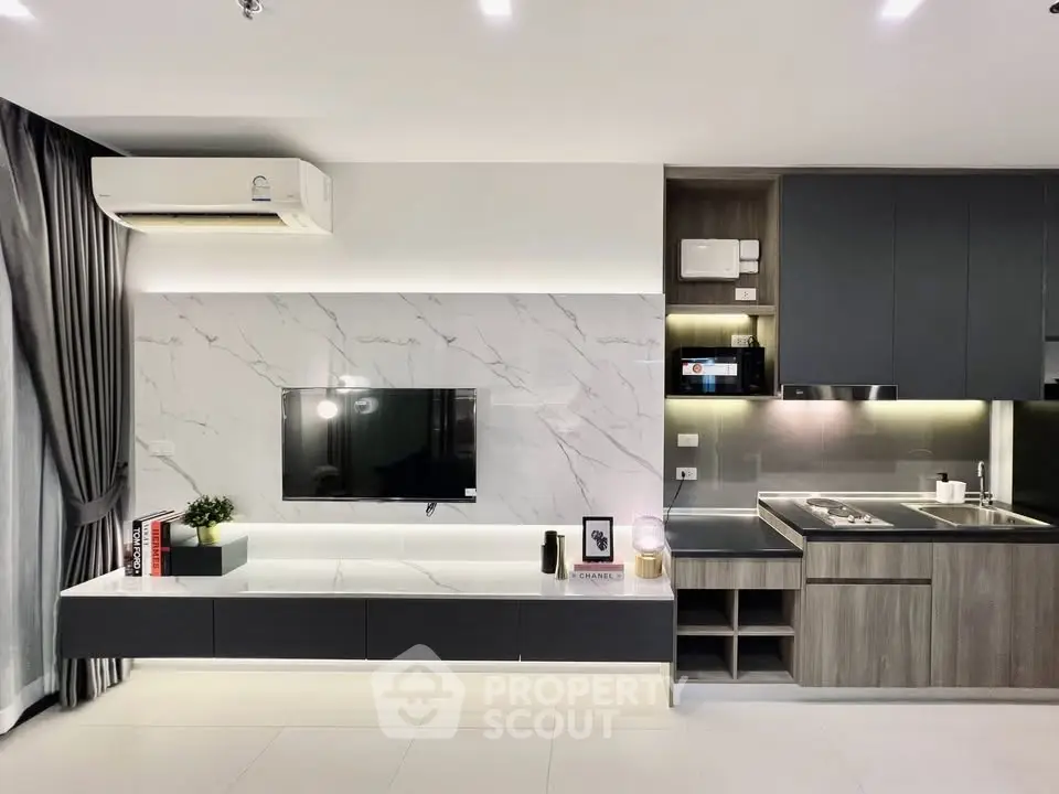 Modern open-layout living room with sleek kitchen and stylish decor