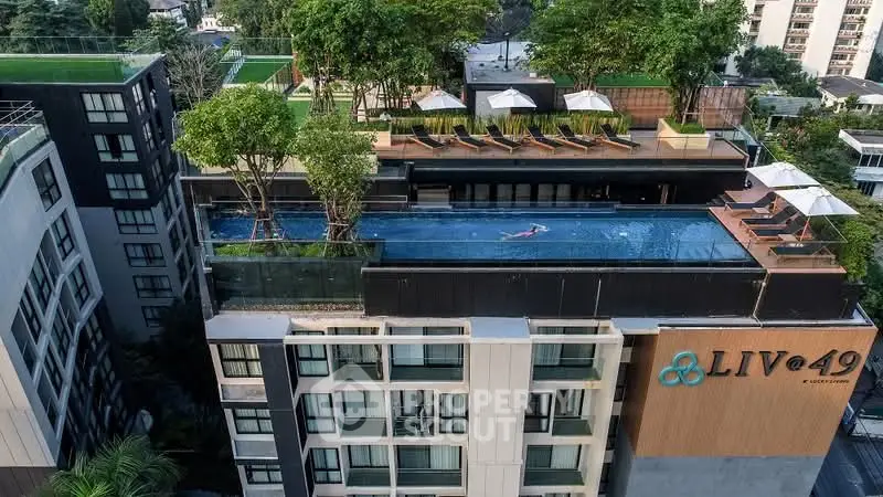 Stunning rooftop pool with lush greenery at LIV@49 luxury condominium, offering a serene urban oasis.
