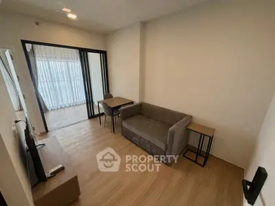 Modern living room with wooden flooring and cozy furniture in a stylish apartment.