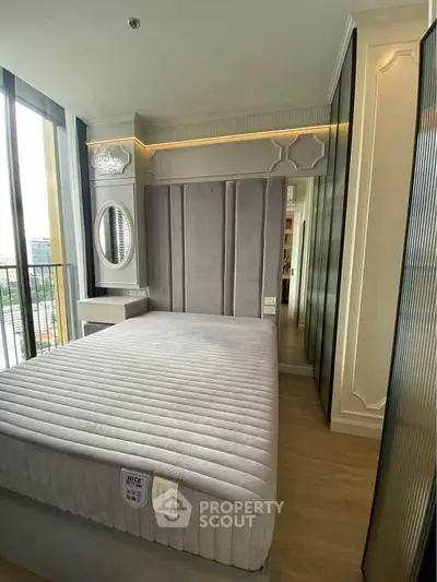 Luxurious bedroom with modern design and large windows offering city views.