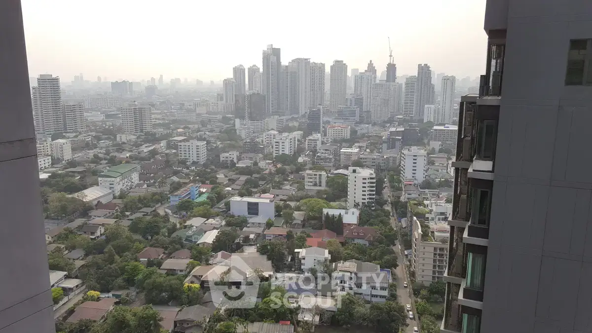 Stunning cityscape view from high-rise building showcasing urban skyline and residential area.