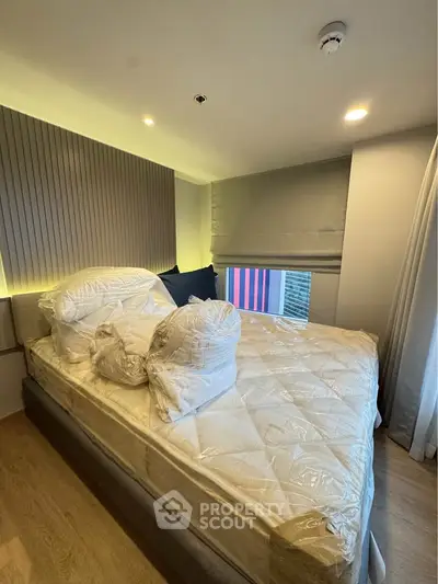 Cozy bedroom with modern design and natural light, featuring a comfortable bed and stylish decor.