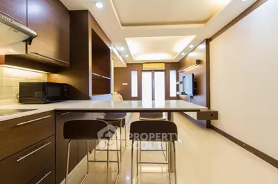 Modern kitchen with sleek design and open layout, featuring a breakfast bar and stylish lighting.