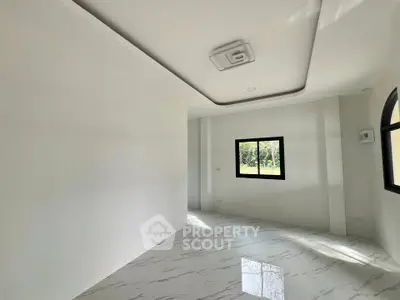 Spacious modern room with elegant ceiling design and large windows