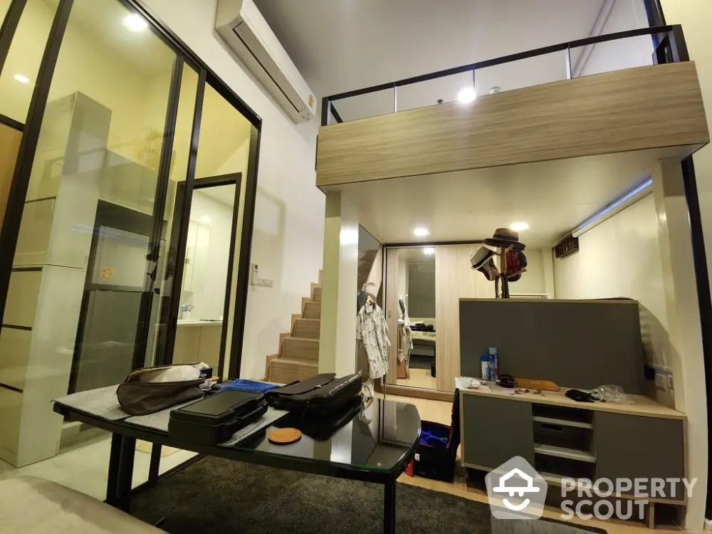 Modern loft apartment with mezzanine, stylish interior design, and open living space.