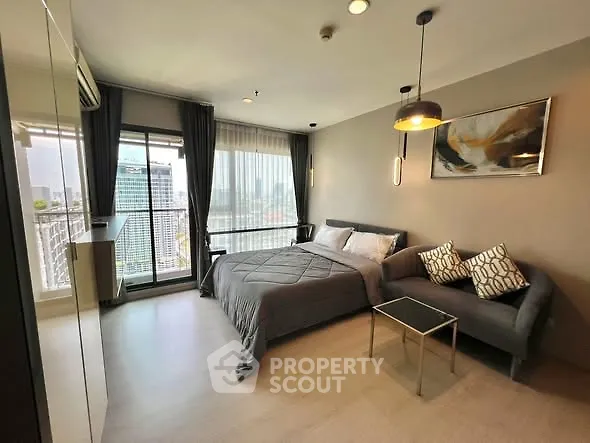 Modern bedroom with balcony and city view in high-rise apartment