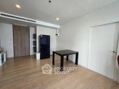 Spacious modern living room with wooden flooring and minimalist furniture