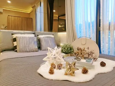 Luxurious bedroom with elegant decor and large windows offering natural light.