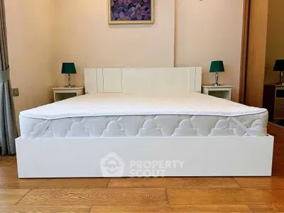 Spacious bedroom with modern white bed and stylish decor