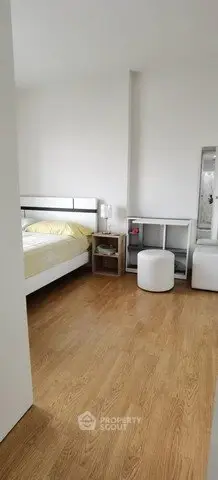 Modern bedroom with wooden flooring and minimalist decor