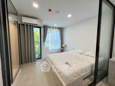 Modern bedroom with balcony access and natural light in stylish apartment