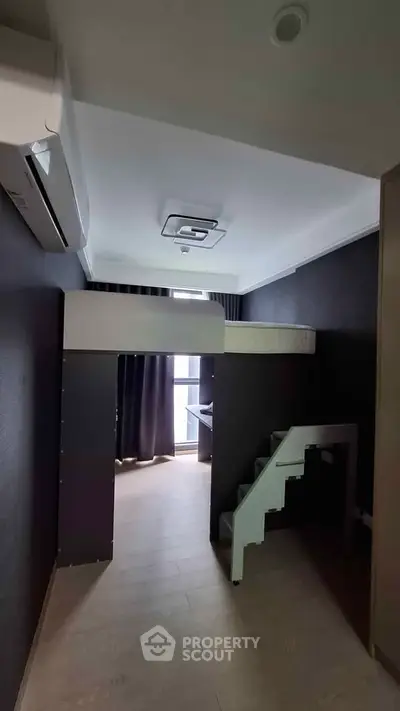 Modern compact bedroom with loft bed and sleek design, maximizing space efficiency.