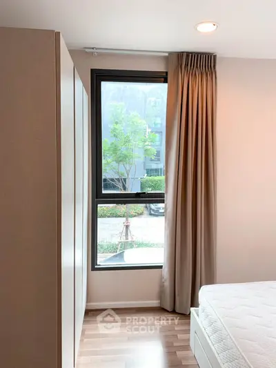 Cozy bedroom with large window and modern decor