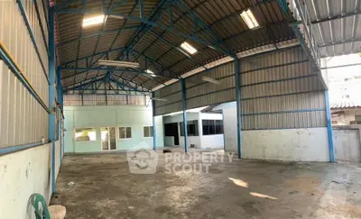 Spacious industrial warehouse with high ceilings and metal framework