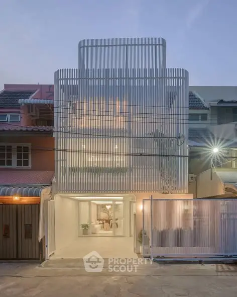 Modern architectural facade of a contemporary urban townhouse with sleek design.