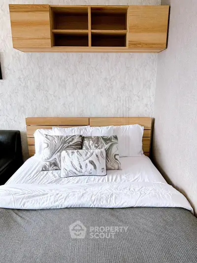 Modern bedroom with stylish wooden shelving and cozy bedding in a contemporary apartment.