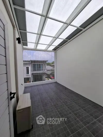 Modern enclosed balcony with sleek design and ample natural light.
