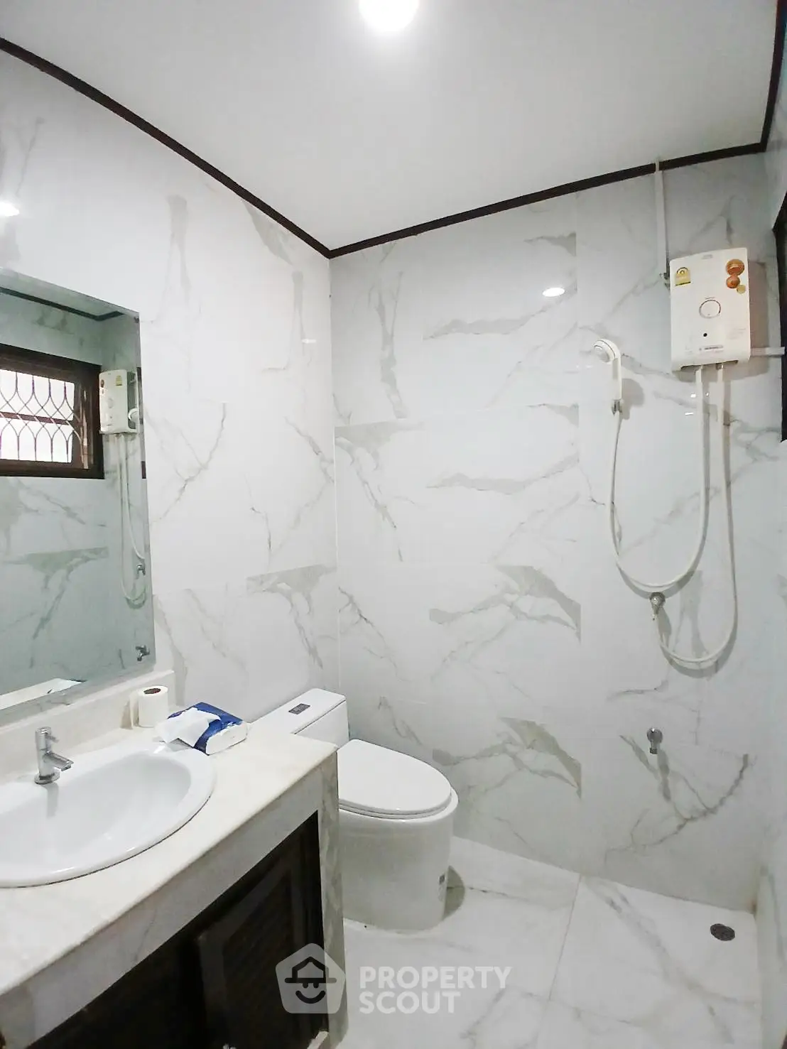 Modern bathroom with marble tiles and sleek fixtures