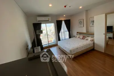 Spacious bedroom with city view and modern furnishings