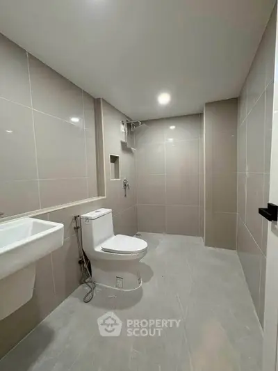 Modern bathroom with sleek tiles and contemporary fixtures in a spacious layout.