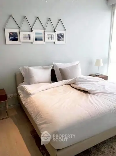 Cozy bedroom with modern decor and soft lighting, perfect for relaxation.