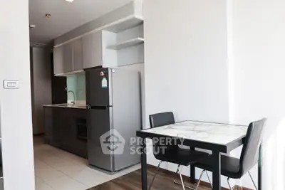 Modern kitchen with sleek appliances and dining area in stylish apartment