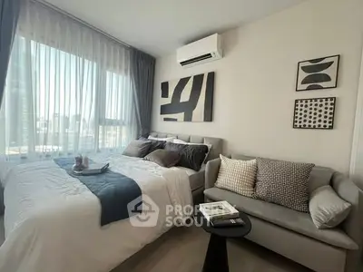 Modern bedroom with stylish decor and large windows offering natural light.