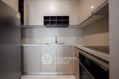 Modern kitchen with sleek cabinetry and built-in appliances in a compact layout.