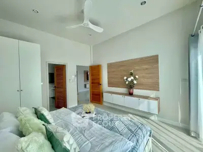 Bright and airy bedroom with modern decor and ample natural light