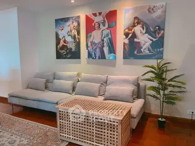 Stylish living room with modern sofa and artistic wall decor in a cozy apartment.
