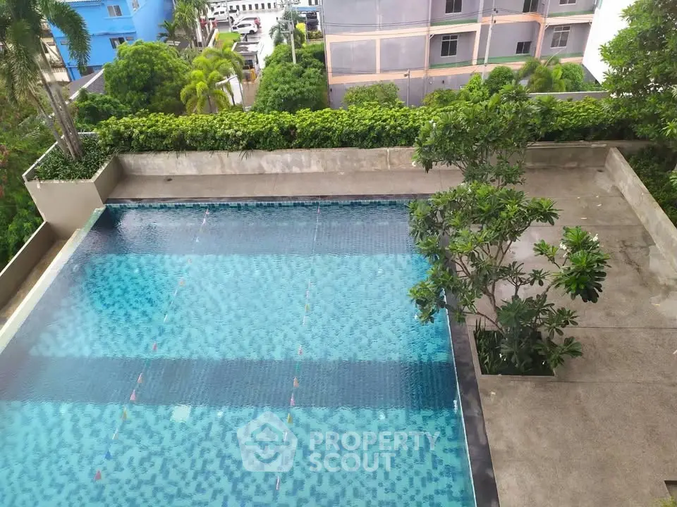 Luxurious rooftop pool with lush greenery and modern design