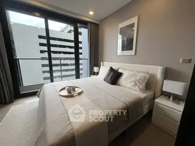 Modern bedroom with large window and stylish decor in urban apartment