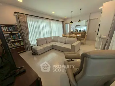 Spacious living room with modern furniture and large windows for natural light.