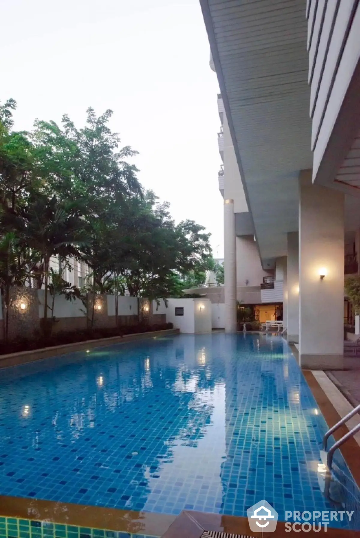 Luxurious condominium with stunning outdoor pool and lush greenery