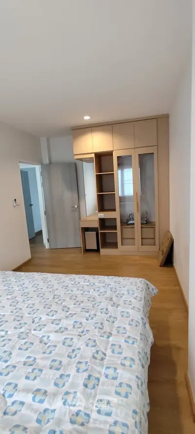 Spacious bedroom with built-in wardrobe and wooden flooring