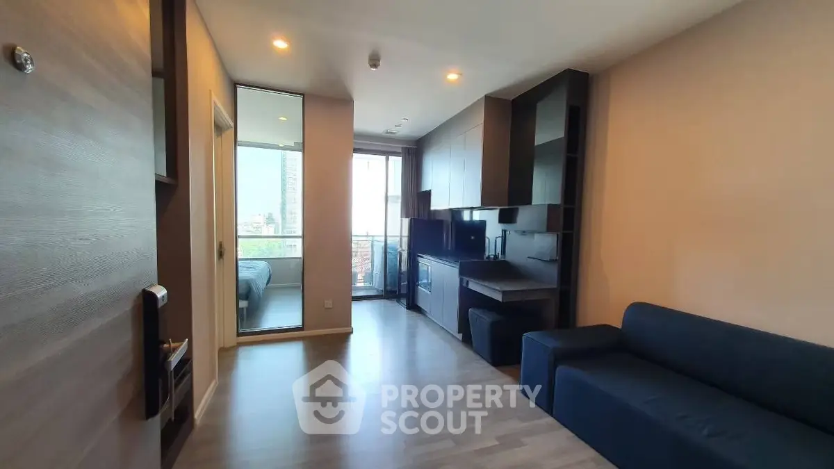 Modern apartment interior with open layout and city view balcony, featuring sleek furniture and stylish design.