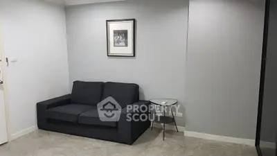 Modern minimalist living room with sleek black sofa and stylish decor