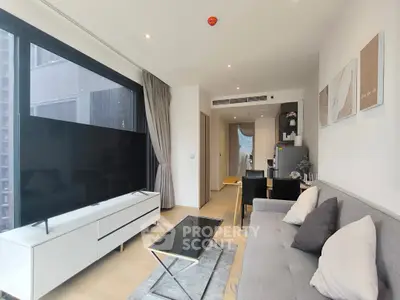 Modern living room with sleek furniture and large TV in a stylish apartment