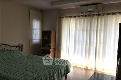 Cozy bedroom with natural light and modern decor