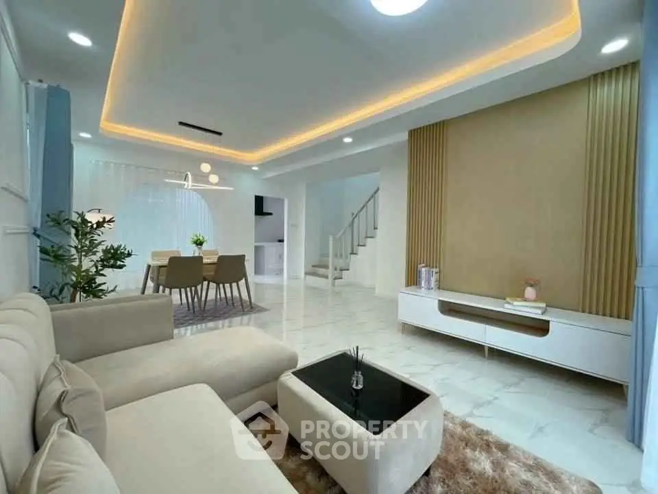 Modern living room with elegant lighting and stylish furniture in a spacious open layout.