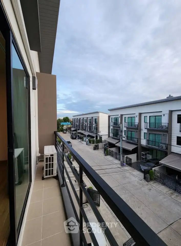 Modern townhouse complex with spacious balconies and scenic views, perfect for urban living.