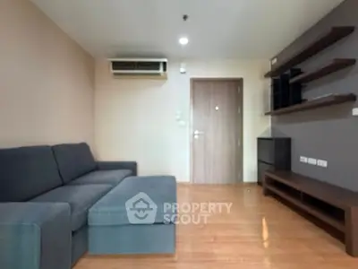 Modern living room with sleek furniture and wooden flooring, perfect for cozy gatherings.