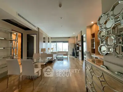 Spacious modern living room with elegant decor and large windows offering natural light.