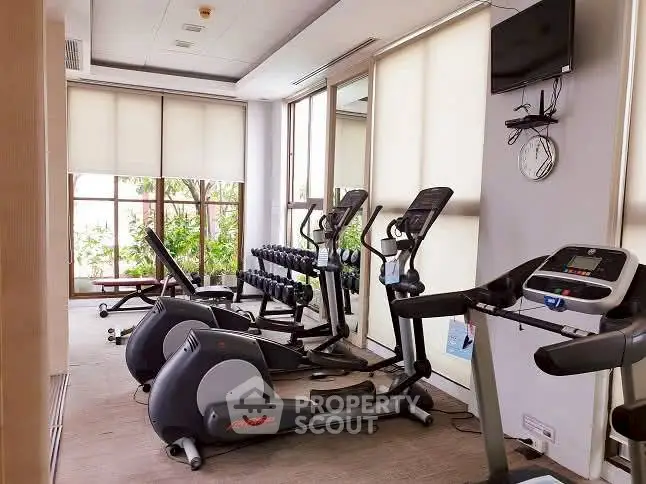 Modern gym with exercise equipment and natural light