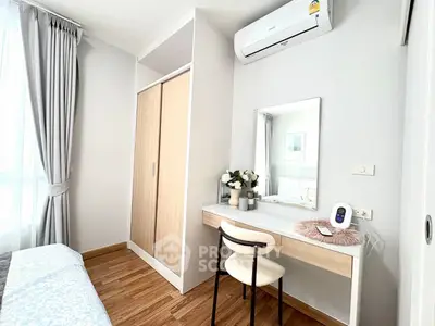 Modern bedroom with stylish vanity and air conditioning