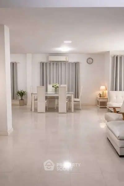 Spacious modern living room with elegant dining area and minimalist decor.
