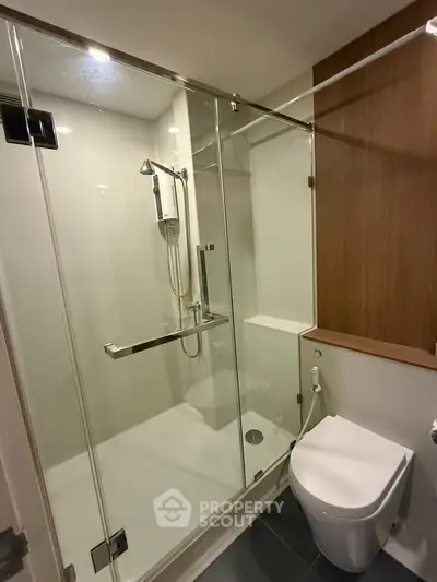 Modern bathroom with glass shower enclosure and sleek toilet design