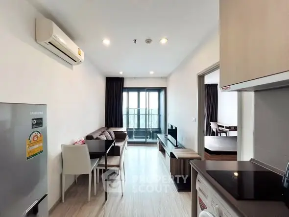 Modern living room with open kitchen and balcony view in stylish apartment