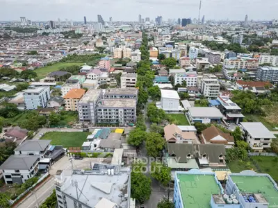 Aerial view of urban residential area with diverse architecture and lush greenery.